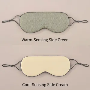 Close-up of double-sided sleep mask with warm green mesh and cool beige silk surfaces