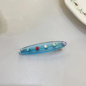 Sparkly blue star hair clip with colorful resin stars on a sweet candy color duckbill clip