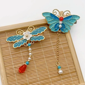 Exquisite Chinese enamel insect hair clips with blue glaze and pearls on a bamboo tray