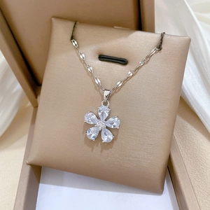 Close-up of silver five-petal flower pendant with sparkling crystals on an O-chain