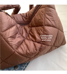 Detail of brown quilted nylon puffer bag with glossy finish and diamond stitching