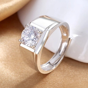 Close-up of a silver men's ring with a large round-cut central stone in a four-prong setting