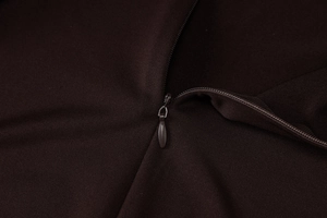 Macro shot of seamless invisible zipper detail on dark brown yoga jumpsuit fabric