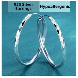 Detail of large 925 sterling silver hoop earrings with diamond-cut texture and hypoallergenic posts