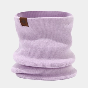 Detail of lavender knitted scarf featuring a brown leather patch with a snowflake pattern