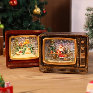 Detail of vintage TV-style Christmas music box with Santa and glowing snow scene