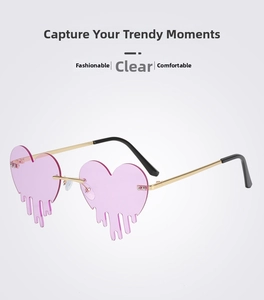 Detail of heart-shaped rimless sunglasses with pink lenses and gold metal teardrop accents