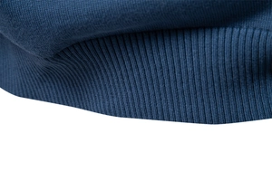 Macro view of dark blue ribbed knit cuffs and hem texture on a men V-neck sweater