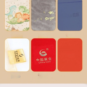 Close-up of custom logos showing digital printing, embroidery, embossing, and gold stamping