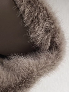 Macro detail of high-quality brown faux fur texture and smooth fabric stitching