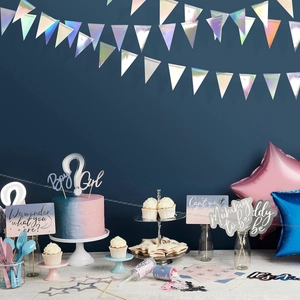 Close-up of iridescent star and moon garland decorations for gender reveal party