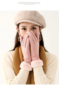 Detail of pink thermal winter gloves with thick faux fur cuffs and soft fabric texture