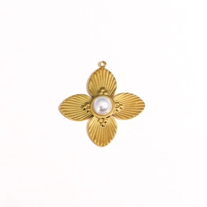 Macro shot of gold floral sun pendant with white pearl inlay and radiating textures