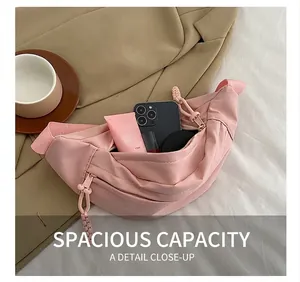 Internal view of pink crescent sling bag showing space for phone and cosmetics