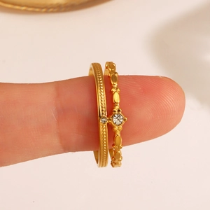 Two-piece 18K gold plated stainless steel rings featuring wave patterns and clear zircons