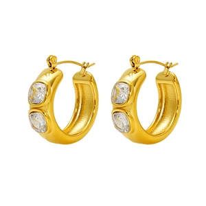 Detail of gold C-shaped earrings with two clear square cubic zirconia stones