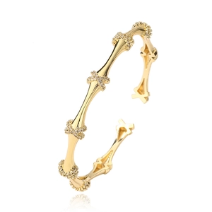 Bamboo style gold plated open bangle featuring cross-shaped cubic zirconia accents