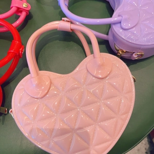 Quilted heart-shaped PVC jelly bags in pink, purple, and red with top handles