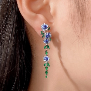 Elegant long drop floral earrings with blue and white enamel flowers and green leaves