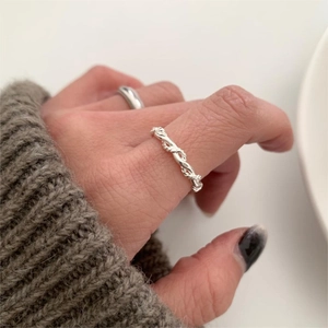 Minimalist 925 sterling silver twisted rope ring and polished band set on finger