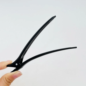 Large matte black seamless hair clip for styling and sectioning on white background