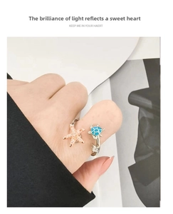 Detailed macro of S925 silver adjustable ring featuring a pink starfish and blue sea turtle