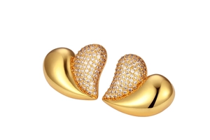 Detailed view of large gold-plated heart earrings with sparkling white cubic zirconia