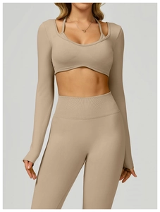 Close-up of seamless knit texture and ribbed hem on a slim-fit long-sleeve yoga top