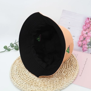 Close-up of double-sided bucket hat featuring cactus embroidery and textured cotton canvas