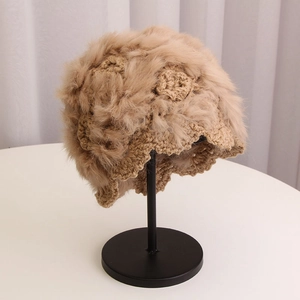 Detailed view of the handmade crochet knit beanie with fluffy fur texture and floral patterns