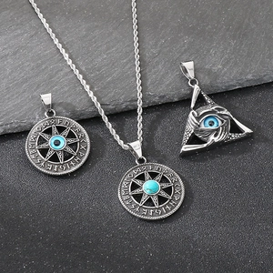 Macro view of vintage Norse Viking pendants with turquoise and evil eye details