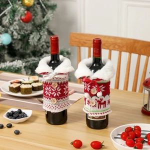 Christmas knitted wine bottle covers with snowflakes and faux fur trim on a dining table