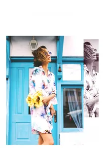 Close-up of floral print summer dress against a blue European style door backdrop