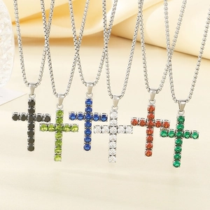 Fashion stainless steel cross necklaces with colorful zircon pendants on beige background