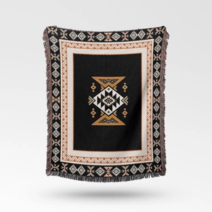 Close-up of bohemian woven blanket featuring geometric patterns and fringe detail
