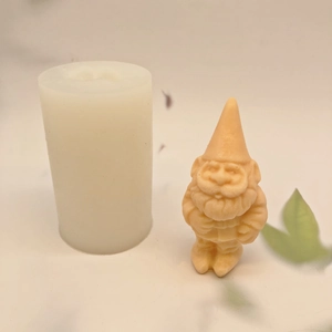 Macro detail of Santa Claus silicone mold and finished resin gnome figure for DIY crafts