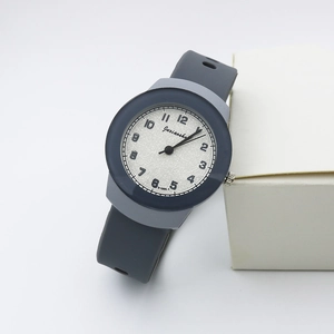 Macro shot of minimalist round dial and flexible silicone strap on sports quartz watch