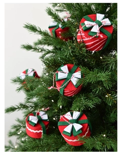 Close-up of red and green felt mini gift box ornaments hanging on a Christmas tree