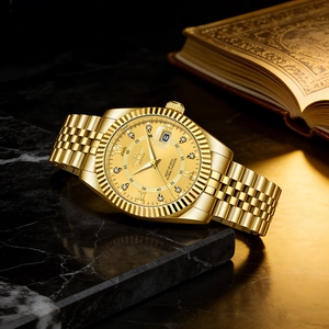 Luxury gold men's watch with calendar on black marble and vintage book background