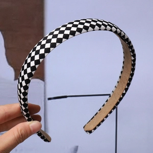 Classic black and white checkered headband featuring a premium light brown suede inner lining