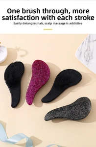Close-up of portable anti-static massage hair combs in glossy black and glittery pink colors