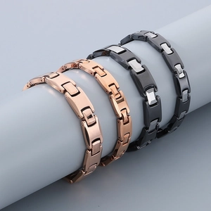 Detail view of tungsten steel bracelets in rose gold and black silver finishes on a display