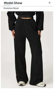 Detail of high-waisted black wide-leg joggers with a cropped drawstring sweatshirt