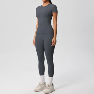 Detail of grey-blue two-piece fitness set with short sleeve top and high waist leggings