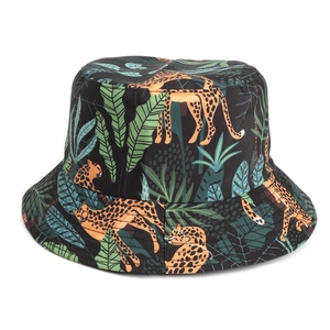 Detail of bucket hat featuring tropical leopard and palm leaf prints on black fabric