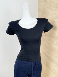 Detail of slim fit black U-neck T-shirt showing soft texture and premium stitching