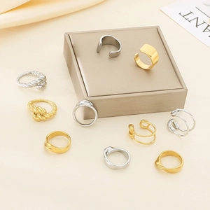 Detail view of gold and silver stainless steel rings with twisted and wide band designs