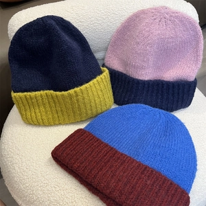 Women's chunky knit bicolor beanie hats in navy, lavender and blue contrasting colors