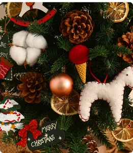 Detail of Christmas tree ornaments with pine cones, cotton balls, and dried orange slices