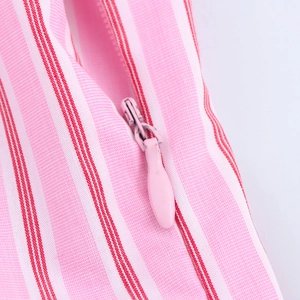 Detail of pink invisible zipper and striped fabric on sweet style camisole top